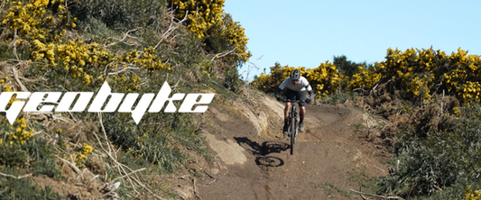 Rider on a GeoByke e-bike descending a rugged Bluff Hill mountain bike trail in Southland